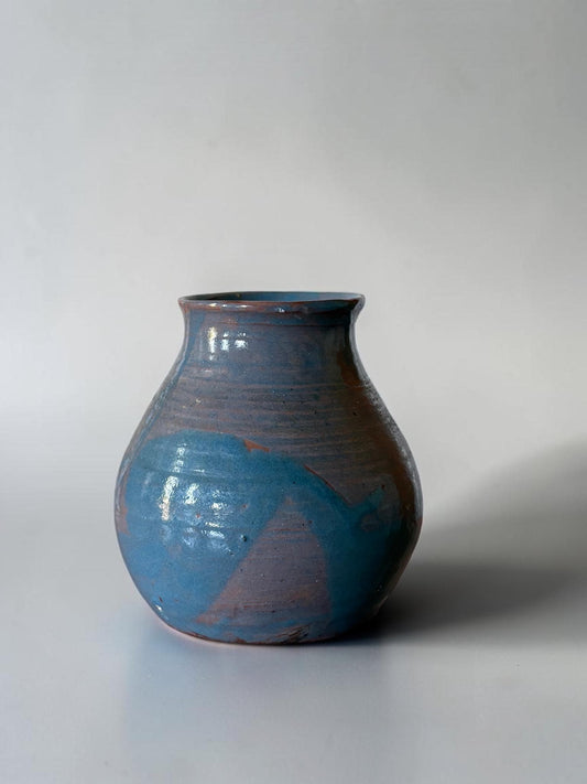 May include: A handmade ceramic vase with a rounded body and a narrow neck. The vase features a blend of blue and brown hues, with a textured surface and a glossy finish. The design includes a splash of blue paint. __etsy:8127165203